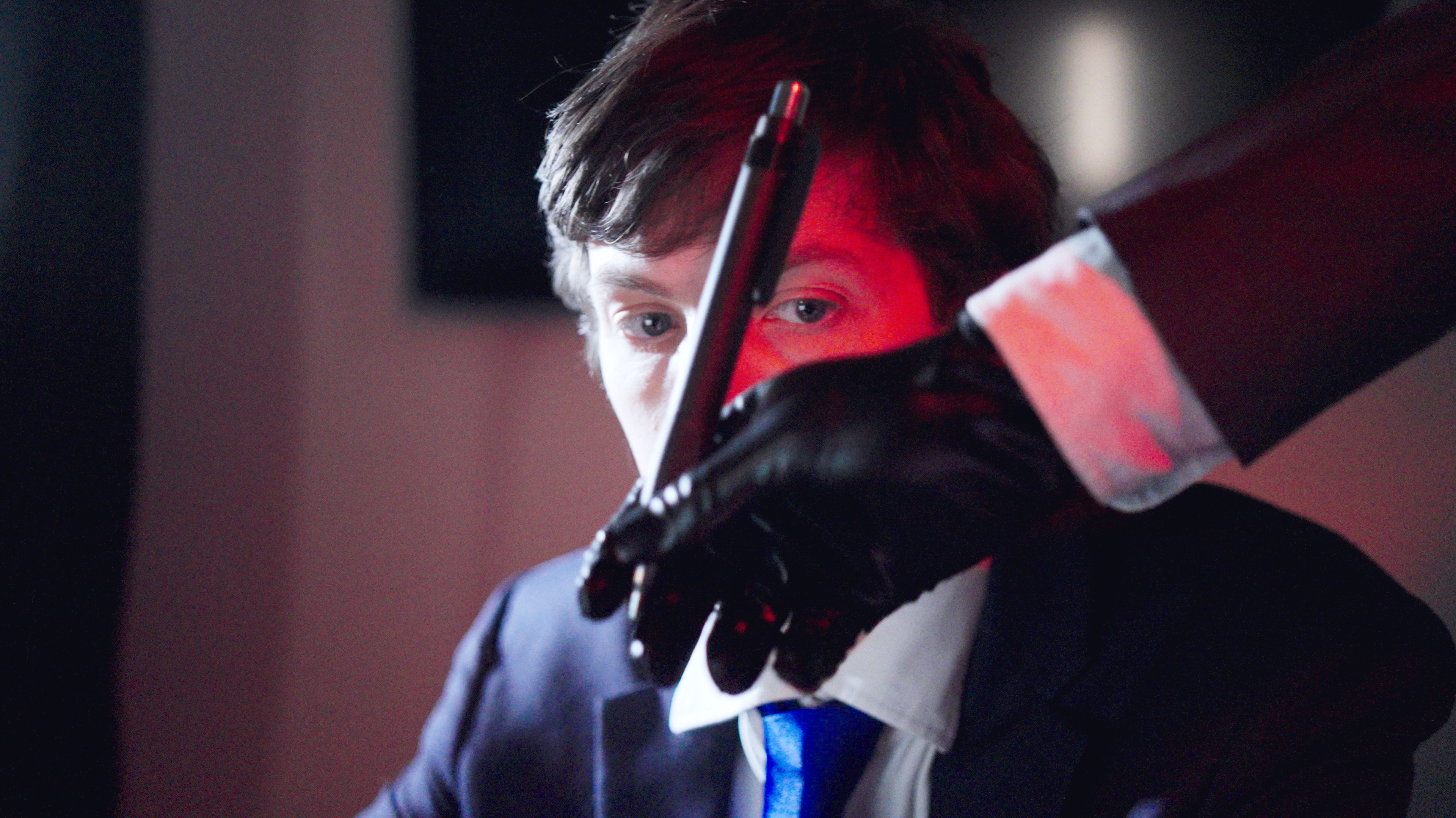 Still from the documentary: a politician sits in the dark